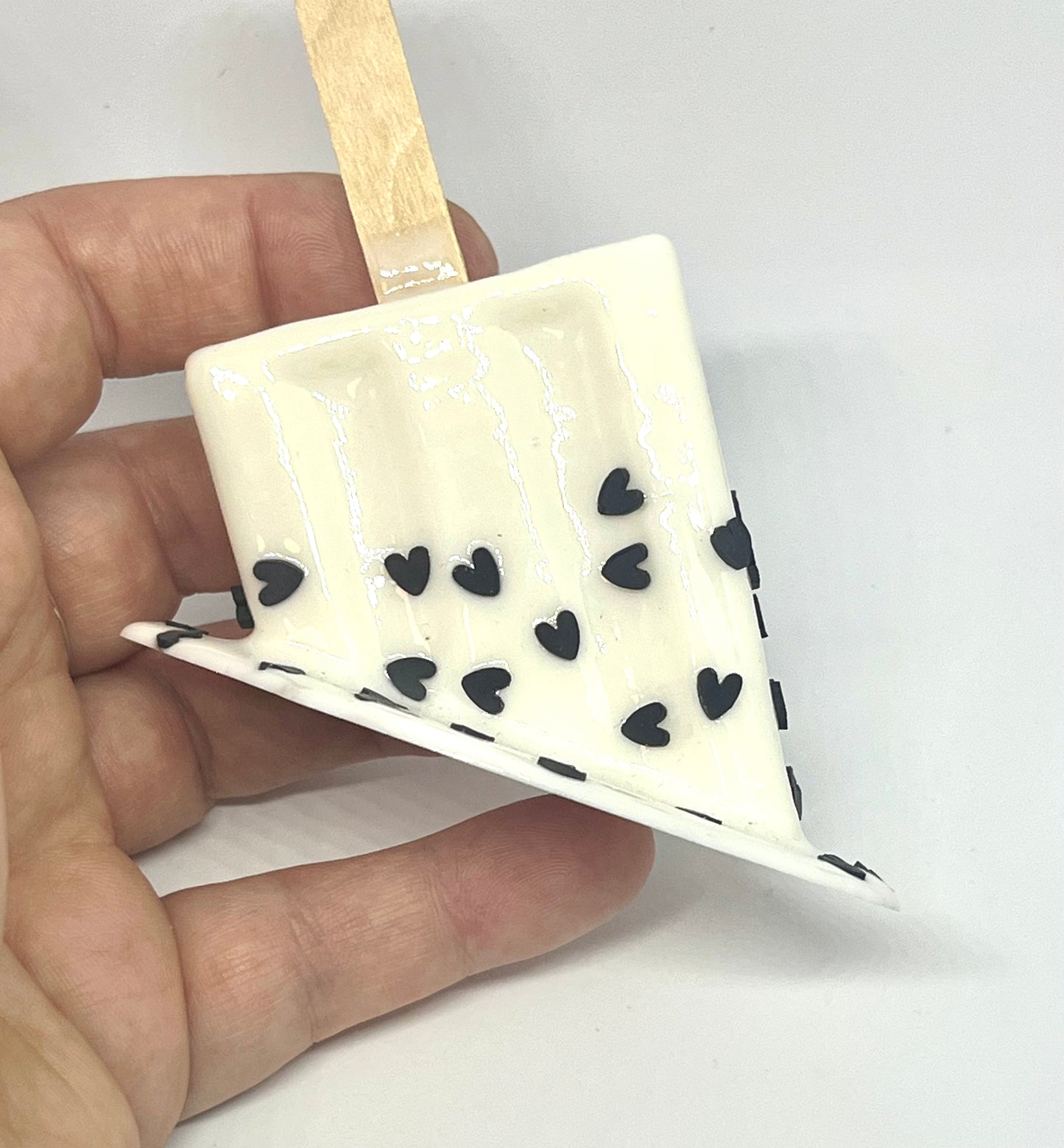 White melting popsicle resin sculpture with black heart sprinkles