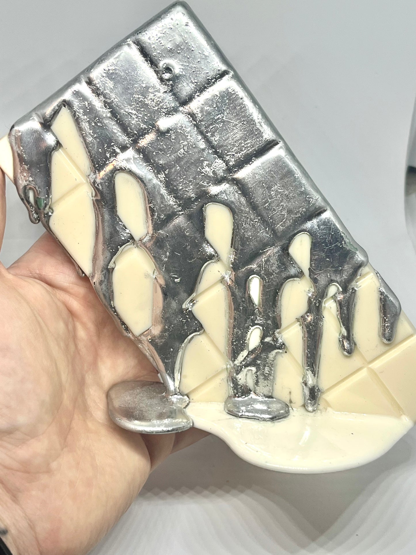 White melting chocolate bar resin sculpture with silver topping
