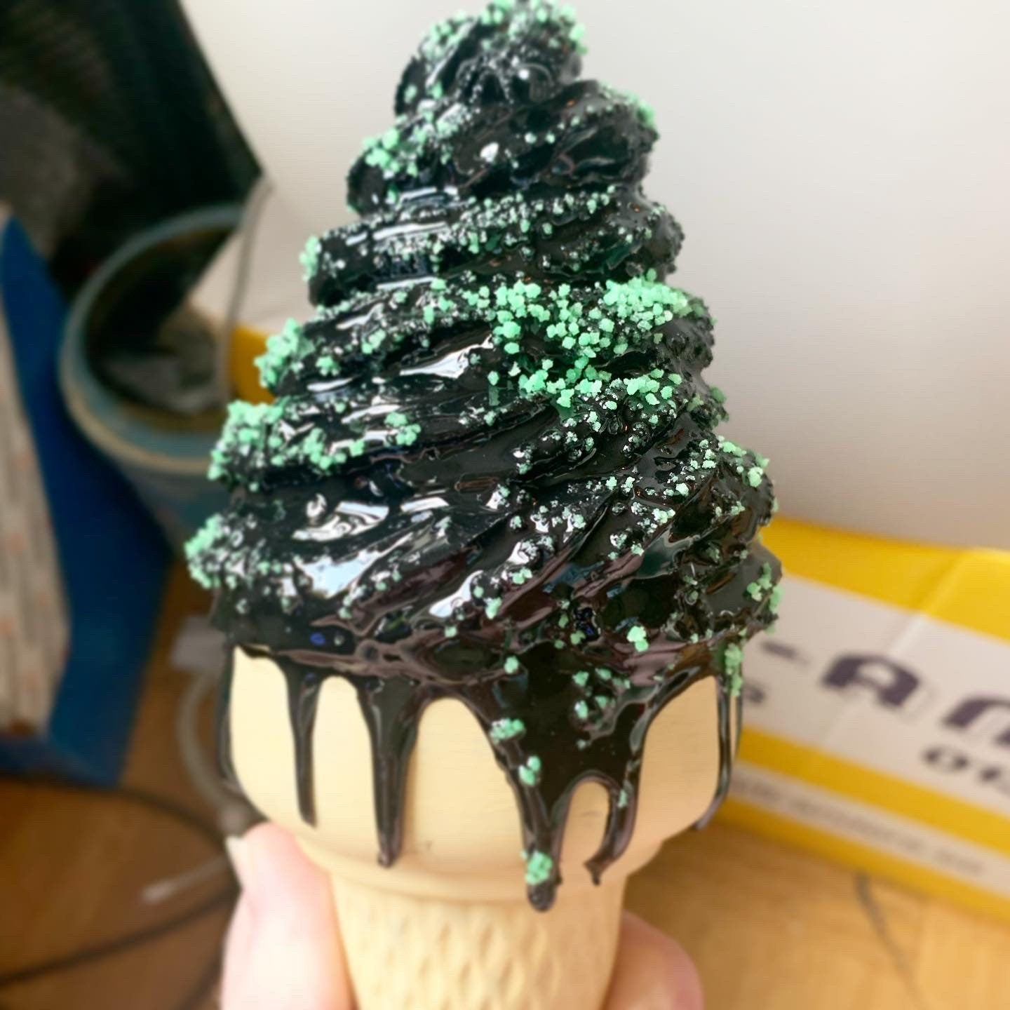 Black Melting Ice Cream Cone With Green Glow In The Dark Sprinkles And Black Spiders