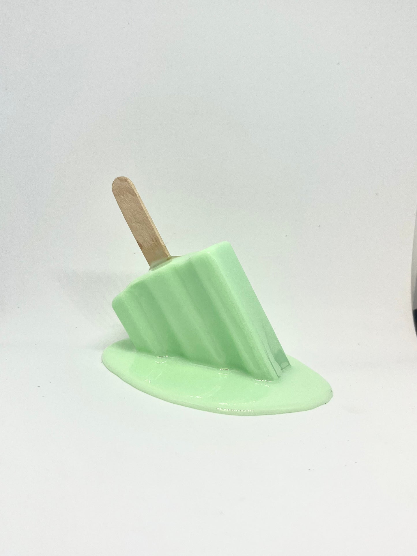 Green melting popsicle resin sculpture
