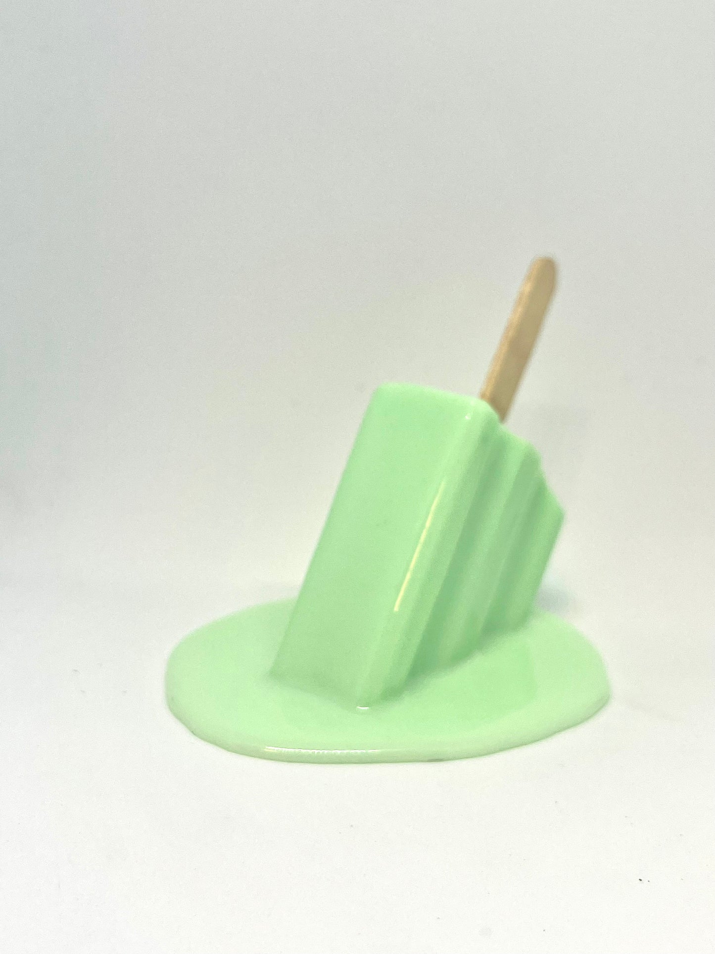 Green melting popsicle resin sculpture