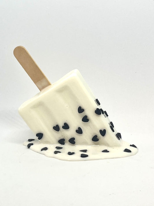 White melting popsicle resin sculpture with black heart sprinkles