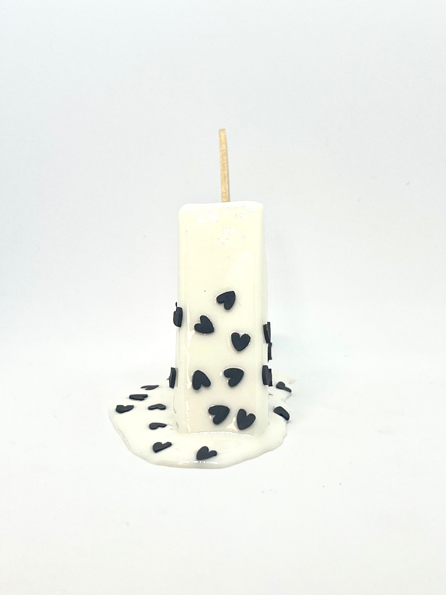 White melting popsicle resin sculpture with black heart sprinkles